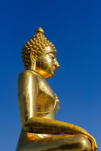 Low angle view of statue against blue sky