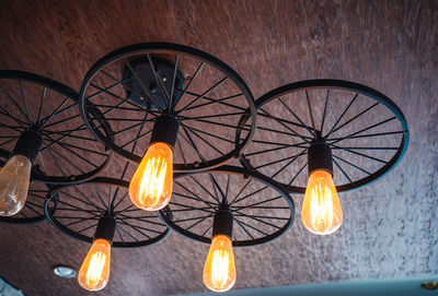 Low angle view of illuminated lights hanging on ceiling