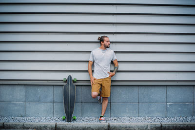 Boy posing with skateboard in hand