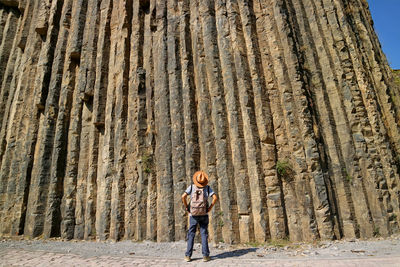 Traveler looking up to 50 meters high breathtaking basalt columns at garni gorge, armenia