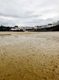 View of beach against cloudy sky