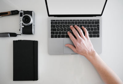 Low section of person using laptop on table