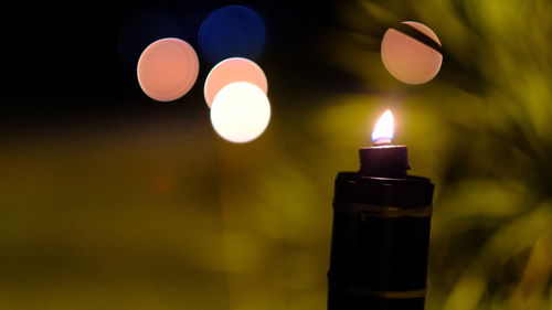 Close-up of illuminated candles on table