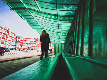 Rear view of woman walking in corridor