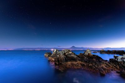 Scenic view of sea against sky at night