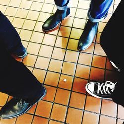 Low section of woman standing on tiled floor