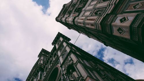 Low angle view of building against cloudy sky