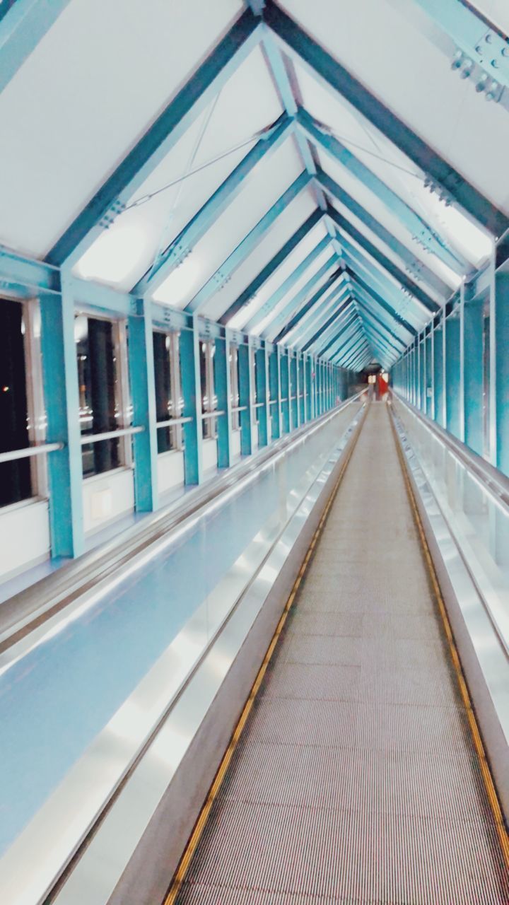 architecture, direction, transportation, diminishing perspective, built structure, the way forward, indoors, rail transportation, public transportation, empty, no people, railroad station platform, railroad station, illuminated, absence, reflection, ceiling, mode of transportation, station