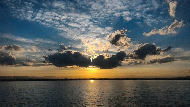 sunset, water, tranquil scene, scenics, tranquility, beauty in nature, sea, sky, waterfront, idyllic, nature, horizon over water, cloud - sky, reflection, silhouette, cloud, sun, orange color, outdoors, sunlight