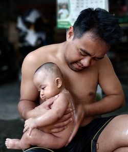 Portrait of shirtless man with hands