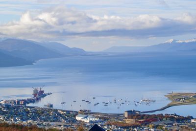 High angle view of townscape by sea against sky