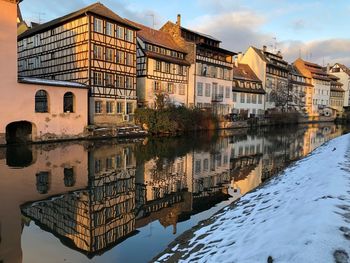 Reflection of building in lake against sky