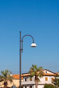 Low angle view of street light against clear blue sky