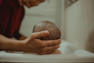 Close-up of mother holding baby head