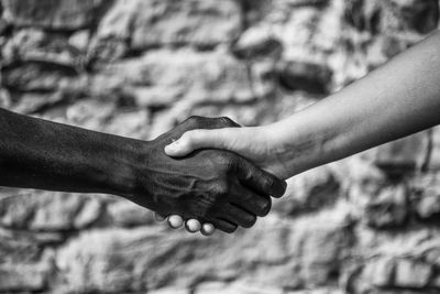 Close-up of multi-ethnic people shaking hands outdoors