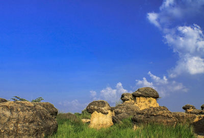 Panoramic view of rocks on field against sky