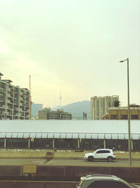 Traffic on road against buildings in city