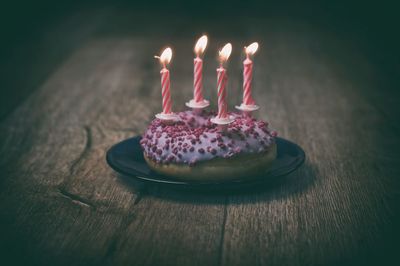 Illuminated cake on table