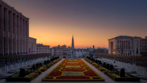 Buildings in city at sunset