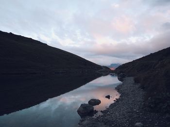 Scenic view of lake amidst mountains against sky