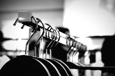 Close-up of coathangers hanging on rack at store