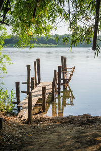 Wooden posts on beach by lake