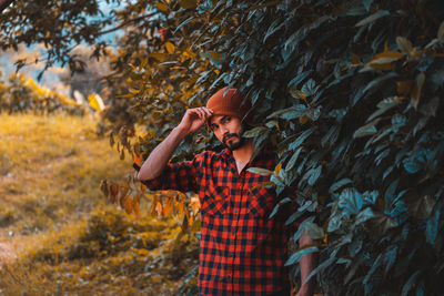 Portrait of young man standing in forest