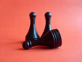 Close-up of chess piece over pink background
