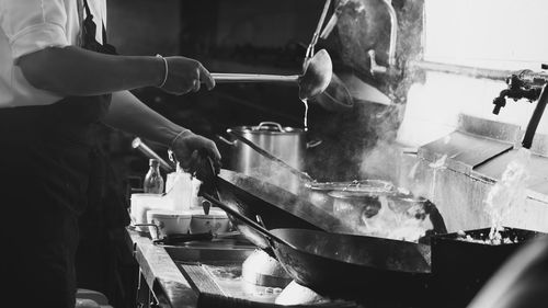 Chef stir fry busy cooking in kitchen. chef stir fry the food in a frying pan, 