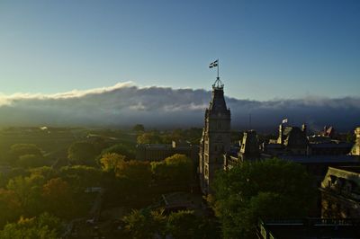 Castle by building against sky