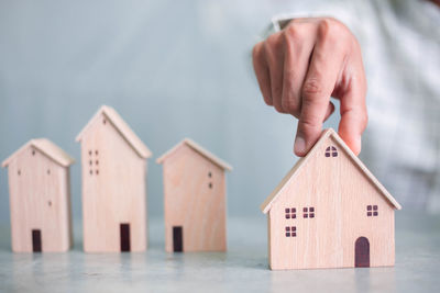 Close-up of hand holding toy against building