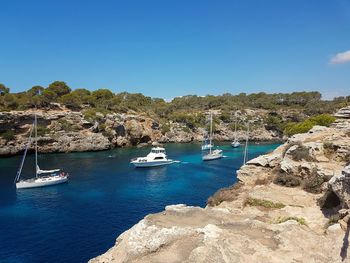 View of boats in sea against blue sky