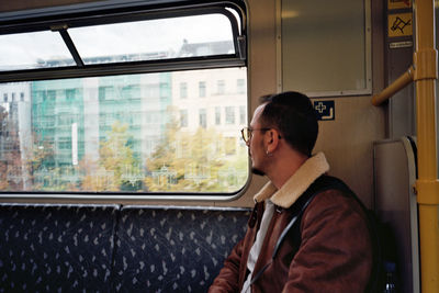 Man looking through train window