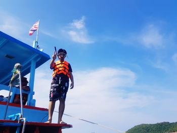 Low angle view of man wearing scuba mask while standing on ferry