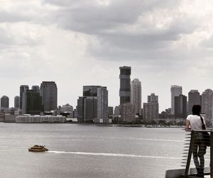 City at waterfront against sky