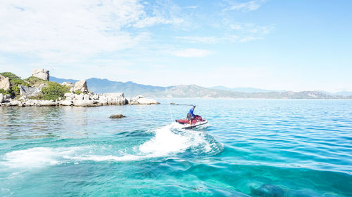 Man jet boating in sea against sky