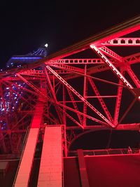 Low angle view of illuminated ferris wheel at night
