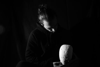 Woman looking away while sitting at home