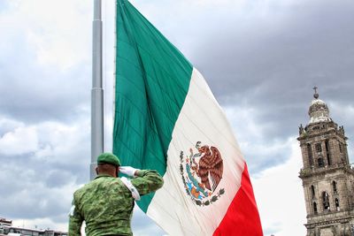 Low angle view of flag against built structure