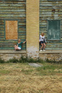 Girls against abandoned building