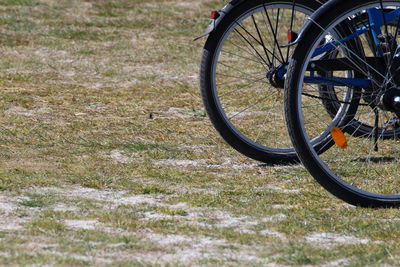 Close-up of bicycle wheel on field