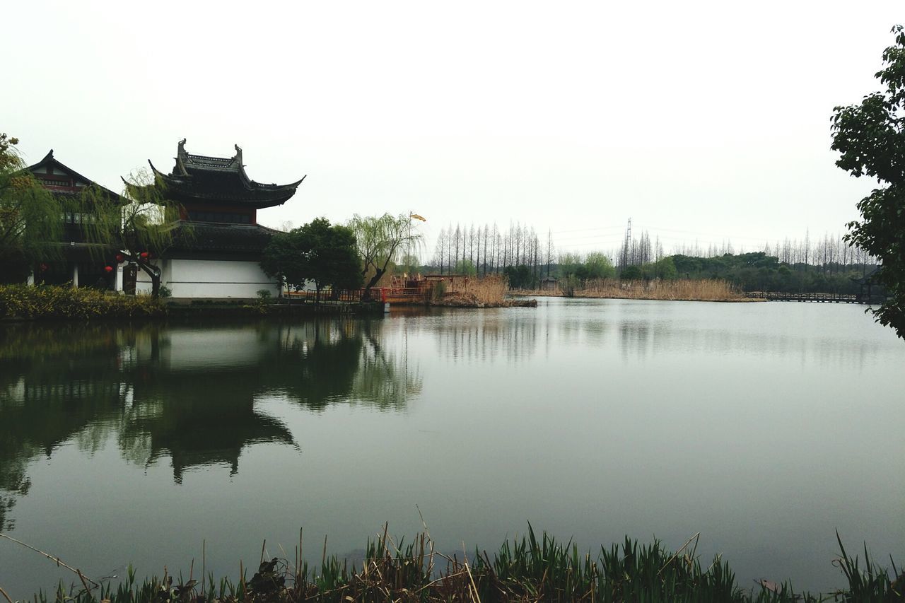 architecture, religion, built structure, place of worship, building exterior, pagoda, spirituality, tree, travel destinations, history, water, day, lake, outdoors, nature, no people, sky, beauty in nature