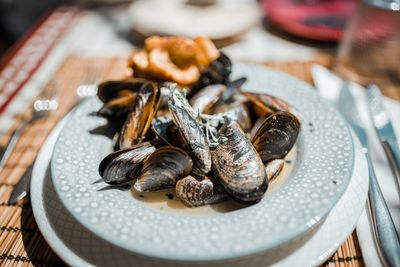 Close-up of mussels in plate on table at restaurant