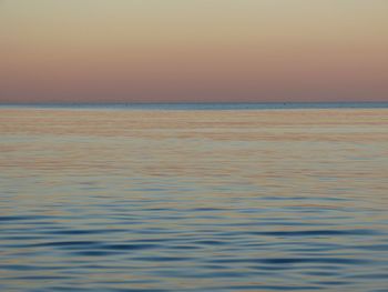 Scenic view of sea against clear sky during sunset