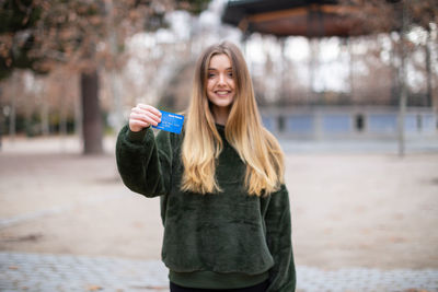 Portrait of smiling young woman standing outdoors