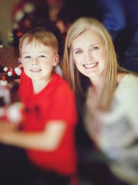 Portrait of smiling mother and son at home during christmas