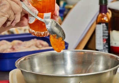 Chef ads jam to the chicken leg marinade bowl