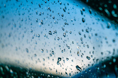 Full frame shot of raindrops on glass window