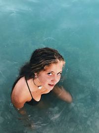 High angle portrait of woman swimming in pool