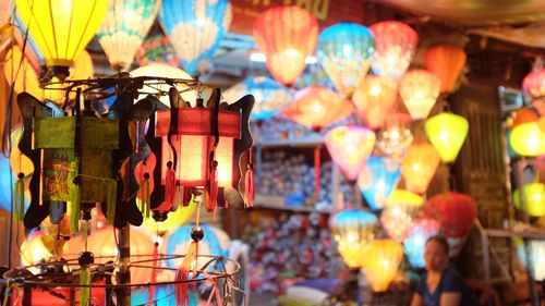 Close-up of illuminated lanterns hanging for sale